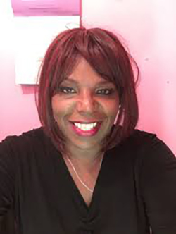 photo of TAG board member Tanya Johnson Walker. Black woman with reddish brown hair, brown eyes, wearing a v-necked top