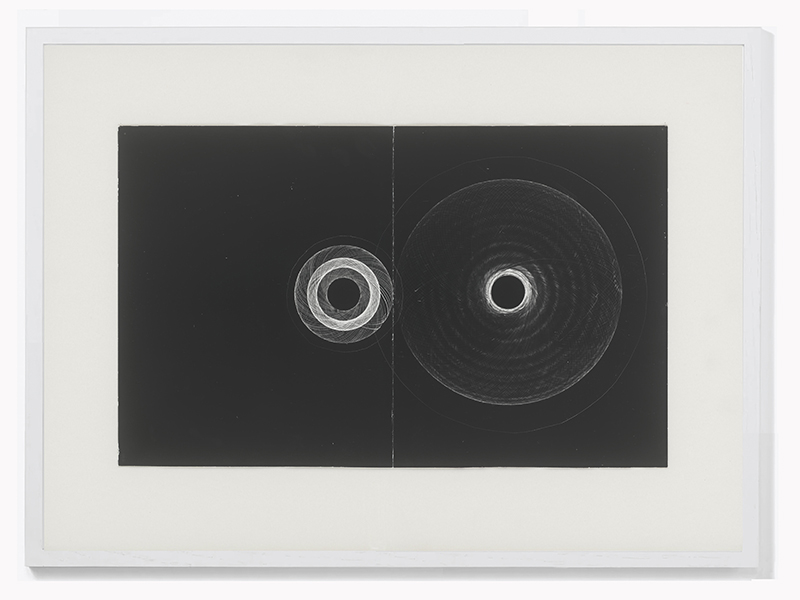 The 2024 Limited Art Edition by David Nelson. Two grey and white circles on a black background. (Note that this is a very simple explanation of this piece)